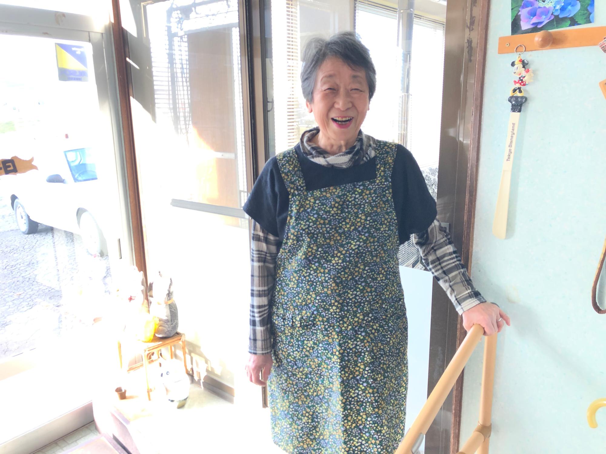 完成した設置型手すりをつかんでいる笑顔の女性の写真