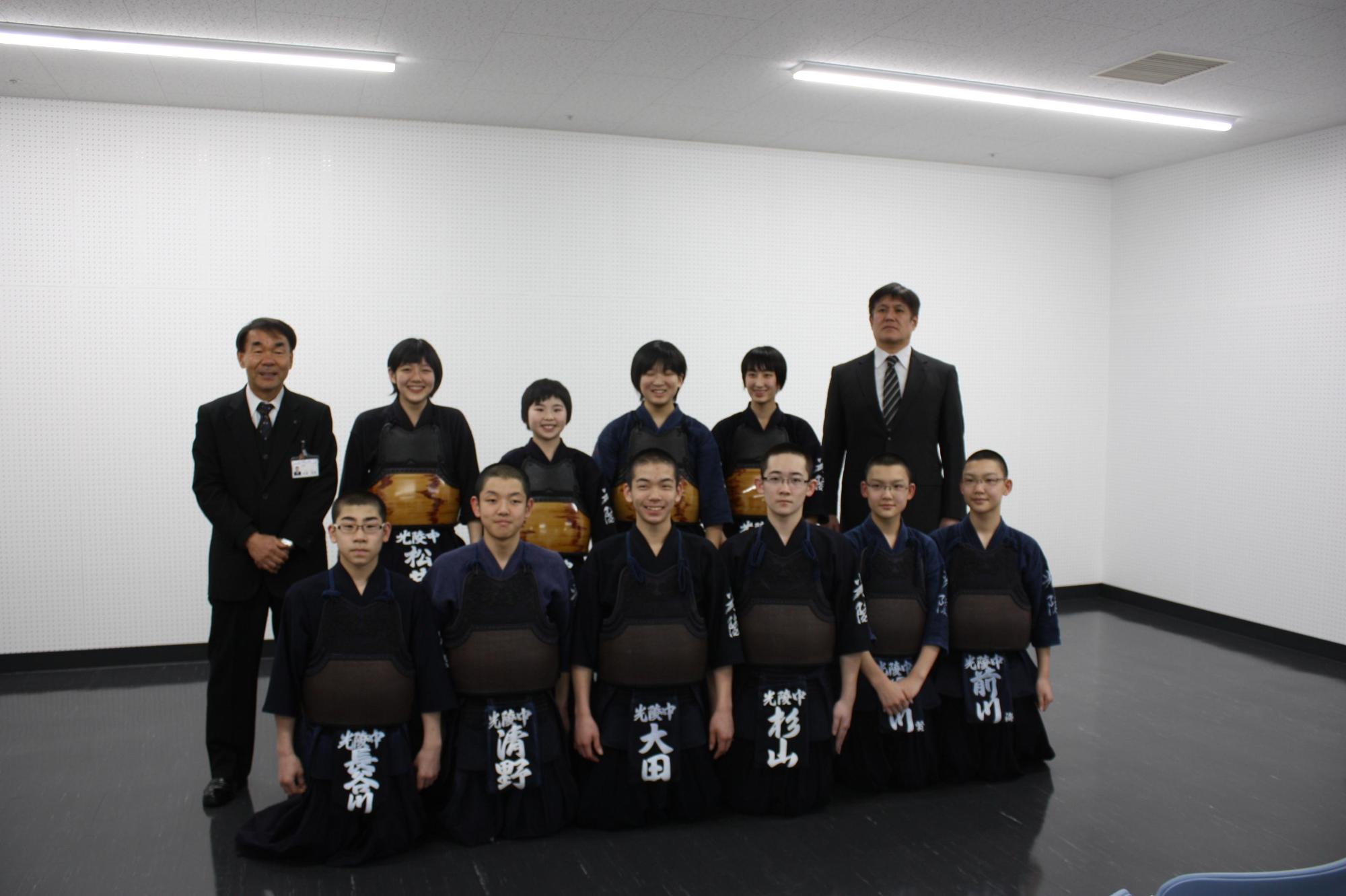 剣道着を着た中学生数人と教育長が記念撮影をした写真。