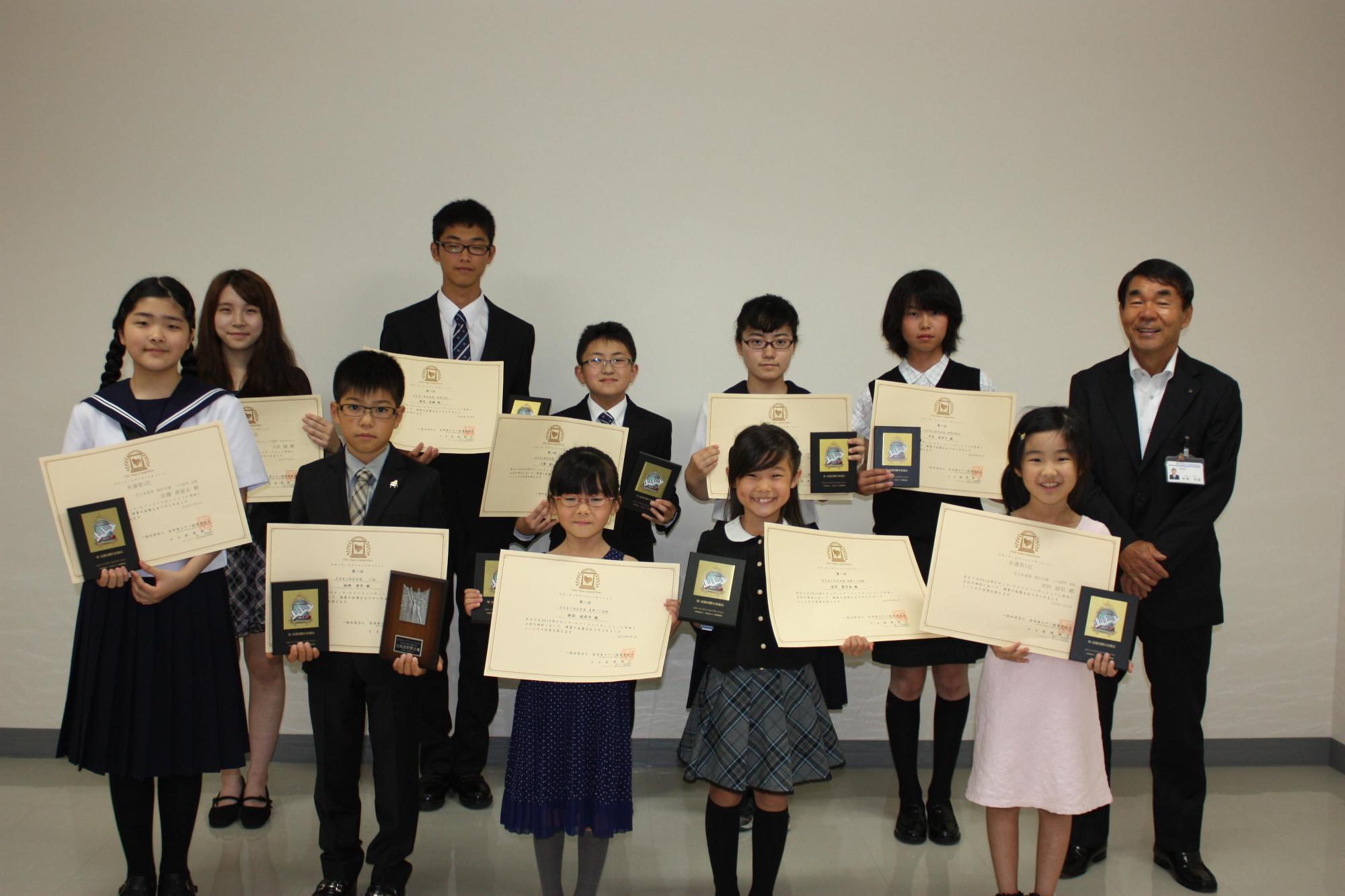 教育長と、10人の賞状をもった男女の子供達が記念撮影をした写真。