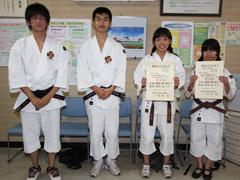 柔道着姿の高校生達4人が賞状を両手で持って撮影されている写真