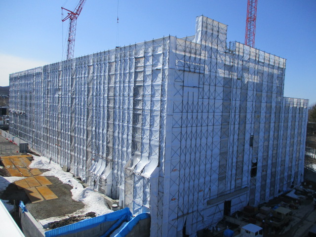工事のシートで覆われた建物の写真。