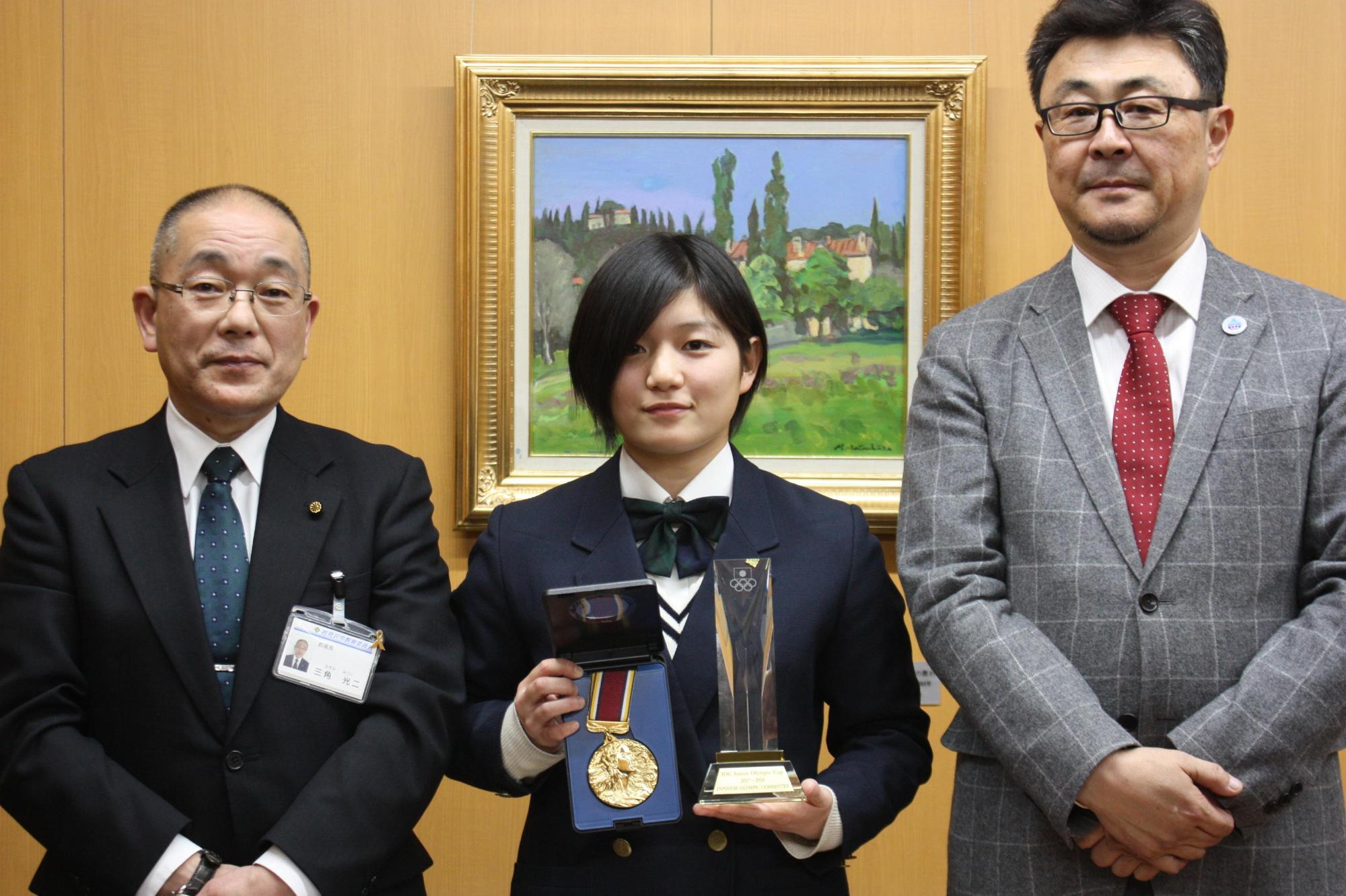スケルトン選手藤原さんと教育長ら2名とメダルを手に記念撮影している写真